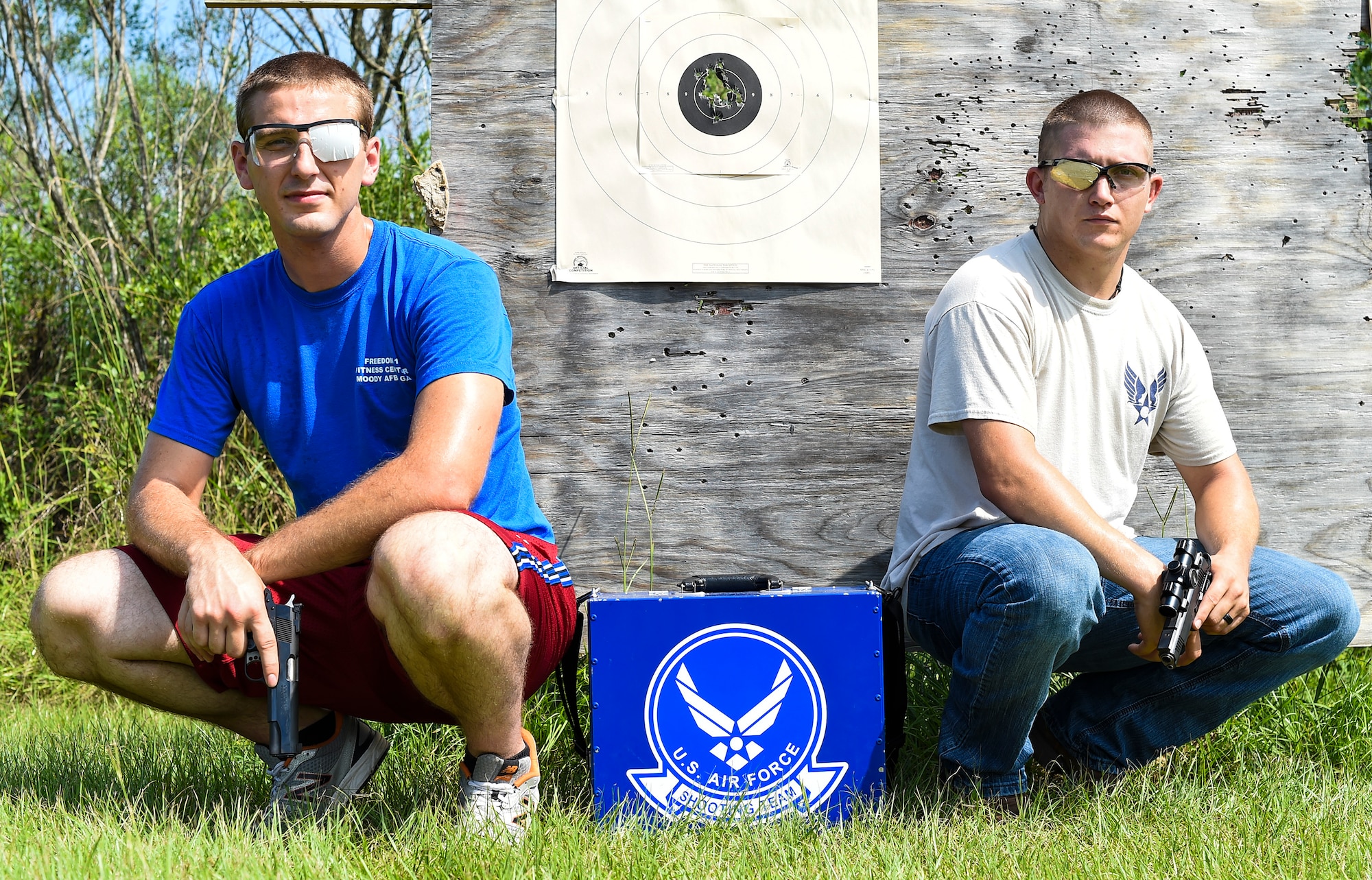 U.S. Air Force Staff Sgt. Jeremiah Jackson, (right), 23d Equipment Maintenance Squadron aircraft metals technology craftsman, and Senior Airman Ian Pitts, 23d EMS munitions flightline delivery crew chief, pose for a photo after pistol shooting practice Sept. 4, 2015, in Valdosta, Ga. Jackson, a member of the Air Force’s National Pistol Team, took Pitts underneath his wing as his protégé to help him perfect his pistol shooting techniques in preparation for team camp.  (U.S. Air Force photo by Senior Airman Ceaira Tinsley/Released)