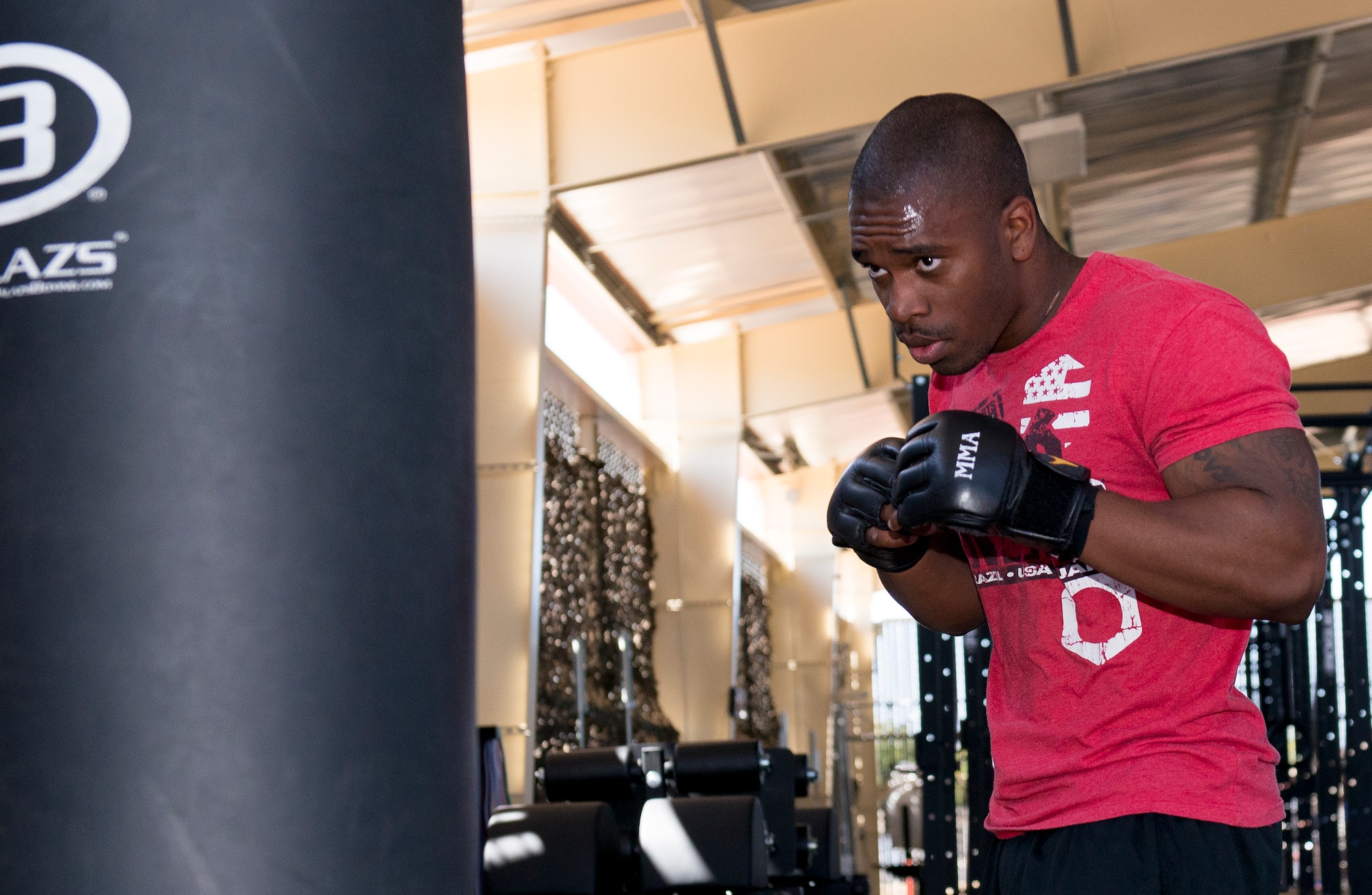 Senior Airman Donovan Greenlee, 60th Operation Support Squadron aircrew flight technician, works on his technique Sept. 8 with a heavy bag at The Jungle, located behind the Fitness Center at Travis Air Force Base, California. (U.S. Air Force Photograph by Heide Couch)