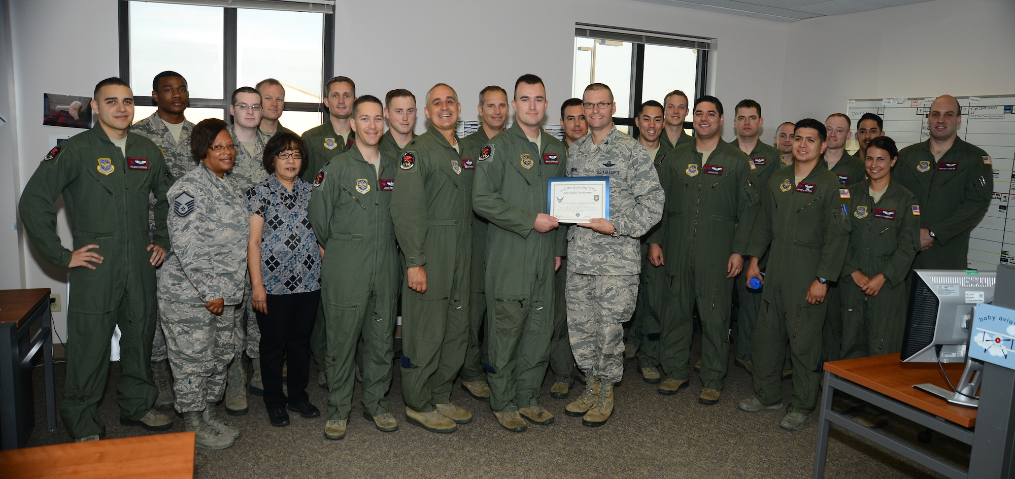 Senior Airman Nicholas Lichtenwalner, 350th Air Refueling Squadron boom operator, poses with Col. Phil Heseltine, 22nd Air Refueling Wing vice commander, and members of the 350th ARS, Sept. 3, 2015, at McConnell Air Force Base, Kan. Lichtenwalner was selected as the spotlight performer for the week of Aug. 30 – Sept. 5. (U.S. Air Force photo by Airman 1st Class Christopher Thornbury)