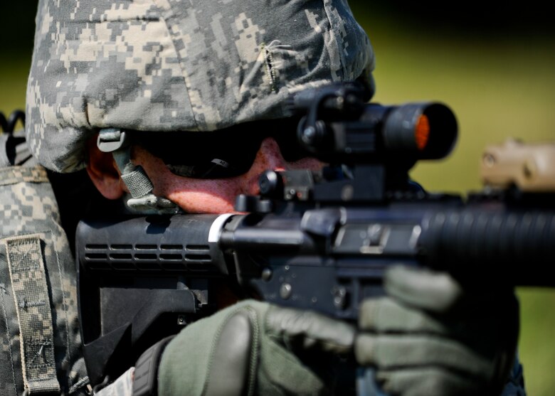 Senior Airman Chad Vanderhoff, 22nd Security Forces Squadron patrolman, monitors an enemy position during a training exercise, Sept. 3, 2015, at McConnell Air Force Base, Kan. Multiple Defenders from the 22nd SFS went through a training exercise to prepare for an upcoming deployment, running through scenarios more likely to be seen while deployed. (U.S. Air Force photo by Senior Airman Victor J. Caputo)
