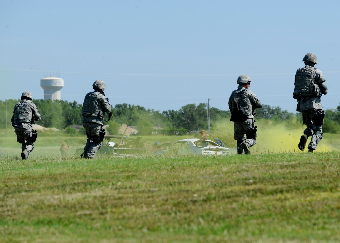 Airmen assigned to the 22nd Security Forces Squadron rush to a defensive position while engaging a simulated enemies during a training exercise, Sept. 3, 2015, at McConnell Air Force Base, Kan. The Defenders with the 22nd SFS focus on security while at home station, while this training covered scenarios more likely to be seen in a deployed location. (U.S. Air Force photo by Senior Airman Victor J. Caputo)