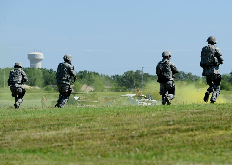Airmen assigned to the 22nd Security Forces Squadron rush to a defensive position while engaging a simulated enemies during a training exercise, Sept. 3, 2015, at McConnell Air Force Base, Kan. The Defenders with the 22nd SFS focus on security while at home station, while this training covered scenarios more likely to be seen in a deployed location. (U.S. Air Force photo by Senior Airman Victor J. Caputo)