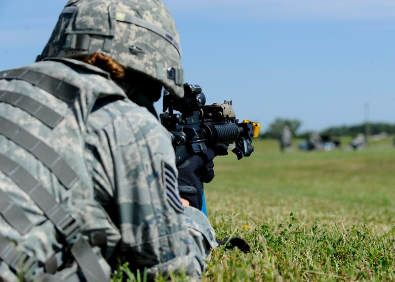 An Airman assigned to the 22nd Security Forces Squadron prepares to return fire to enemy combatants during a training exercise, Sept. 3, 2015, at McConnell Air Force Base, Kan. Several Defenders from the 22nd SFS went through the training to prepare a deployment-centric skillset before an upcoming deployment. (U.S. Air Force photo by Senior Airman Victor J. Caputo) 