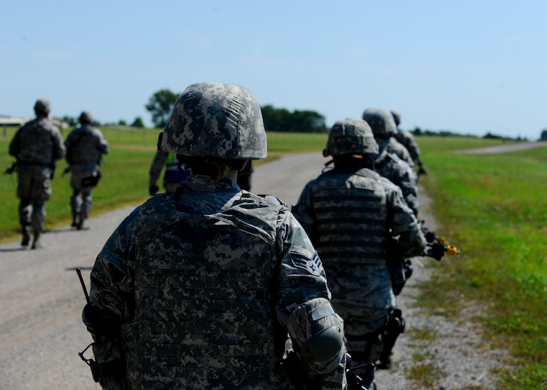 Defenders assigned to the 22nd Security Forces Squadron patrol a road during a training exercise, Sept. 3, 2015, at McConnell Air Force Base, Kan. The exercise covered a simulated mission to capture a high value target in a deployed environment. (U.S. Air Force photo by Senior Airman Victor J. Caputo)