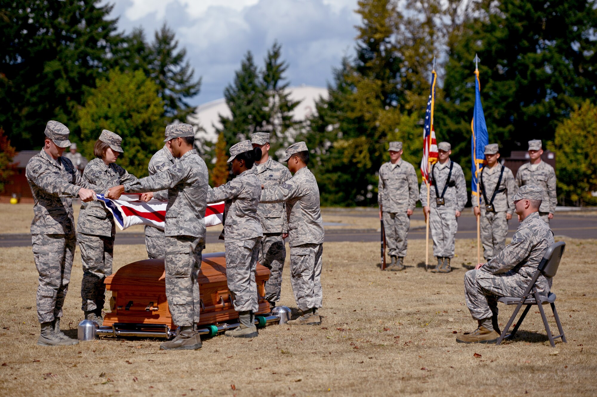Members of the McChord Field Honor Guard fold a flag, Sept. 2, 2015, during a demonstration of an active duty honors ceremony at Joint Base Lewis-McChord, Wash. During funerals, after the flag is folded, it is then presented to the next of kin of the deceased member. (U.S. Air Force photo/Airman 1st Class Keoni Chavarria)