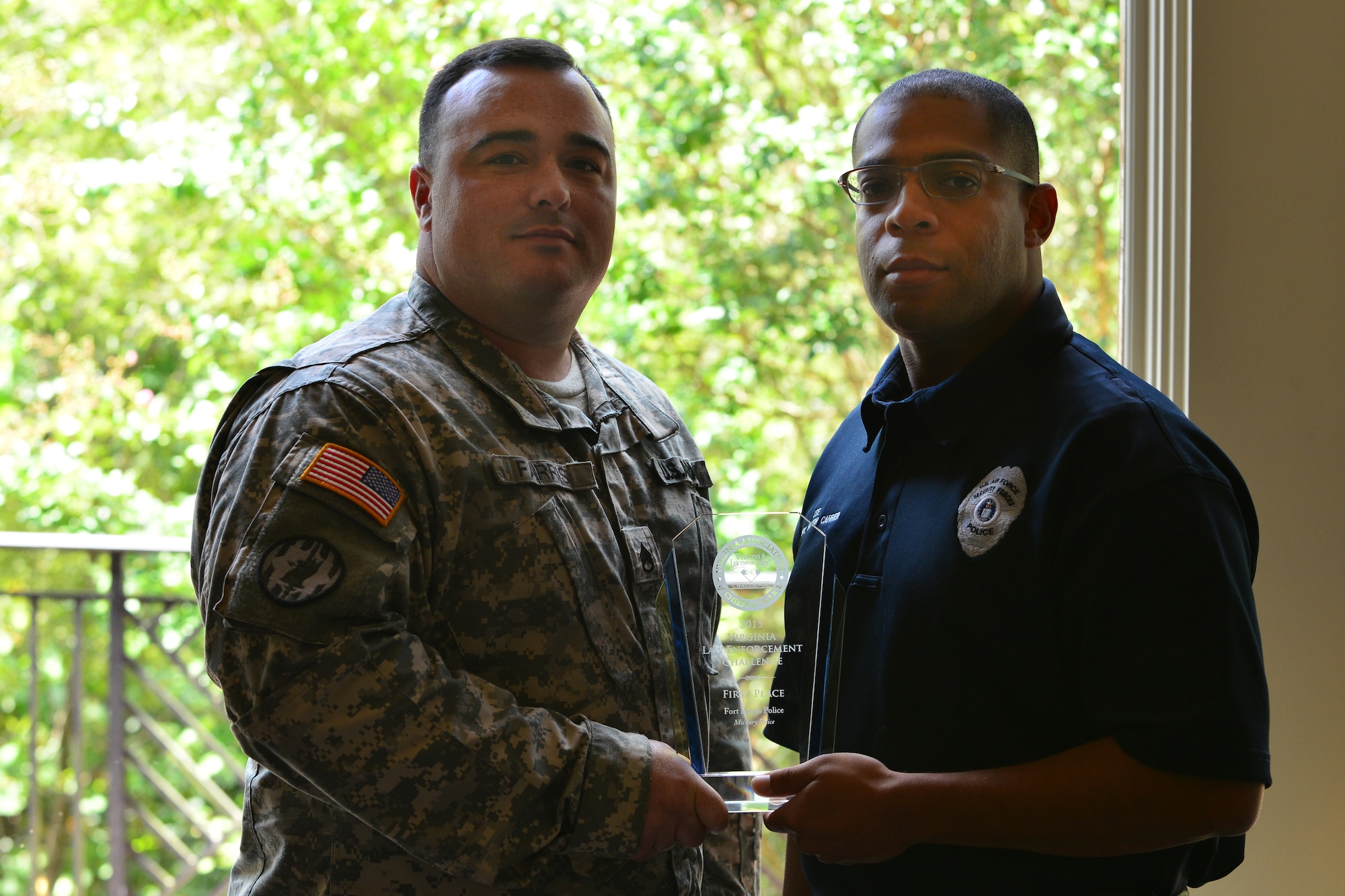 U.S. Army Staff Sgt. Nicholas Farris, 733rd Security Forces Squadron traffic collision reconstructionist, and  Derrick Lee, 733rd SFS traffic motor carrier, accept the Virginia Law Enforcement Challenge  military law enforcement award on behalf of the 733rd SFS, Sept. 1, 2015, in Williamsburg, Va. The award is granted to law enforcement teams that best enforce laws and educate the public about protection, impaired driving and speeding. (U.S. Air Force photo by Staff Sgt. Natasha Stannard/Released)