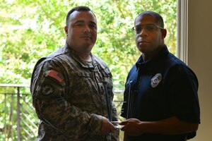 U.S. Army Staff Sgt. Nicholas Farris, 733rd Security Forces Squadron traffic collision reconstructionist, and  Derrick Lee, 733rd SFS traffic motor carrier, accept the Virginia Law Enforcement Challenge  military law enforcement award on behalf of the 733rd SFS, Sept. 1, 2015, in Williamsburg, Va. The award is granted to law enforcement teams that best enforce laws and educate the public about protection, impaired driving and speeding. (U.S. Air Force photo by Staff Sgt. Natasha Stannard/Released)