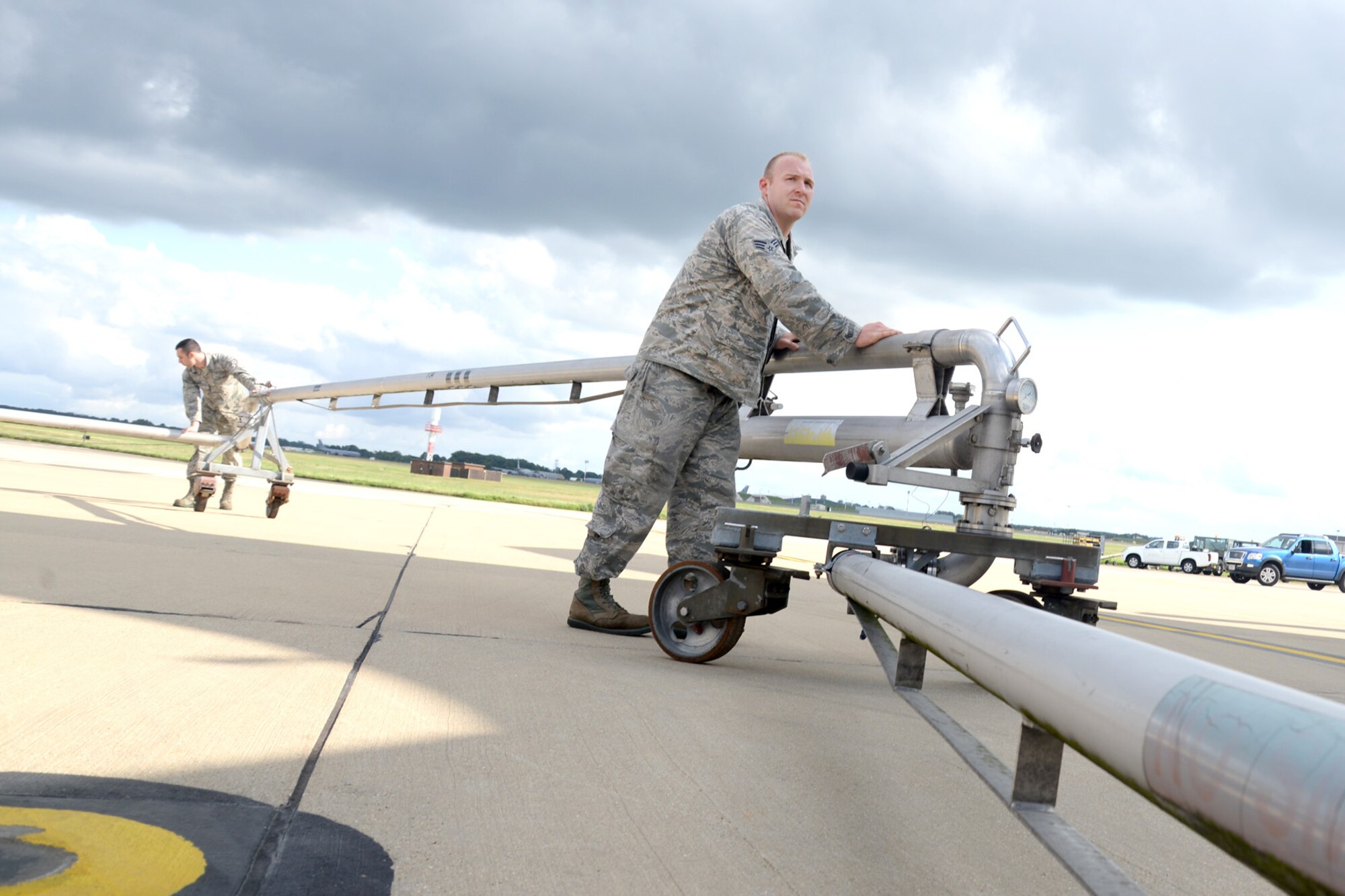 U.S. Air Force Senior Airman Nicholas Clendenen, right, 100th Logistics Readiness Squadron fuels technician, and U.S. Air Force Staff Sgt. Zachary Kiniry, 100th LRS fuels distribution supervisor, position a pantograph Sept. 1, 2015, before refueling a transient aircraft on RAF Mildenhall, England. The pantograph eliminates the need for a fuels truck and makes pumping large quantities of fuel into aircraft more efficient. (U.S. Air Force photo by Senior Airman Kate Thornton/Released)