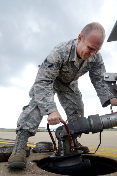 U.S. Air Force Senior Airman Nicholas Clendenen, 100th Logistics Readiness Squadron fuels technician, attaches a pantograph to a fuel line Sept. 1, 2015, before refueling a transient aircraft on RAF Mildenhall, England. The pantograph allows fuel to flow from underground piping to aircraft parked near fuel pumps, making it possible to transfer large quantities of fuel quickly. (U.S. Air Force photo by Senior Airman Kate Thornton/Released)