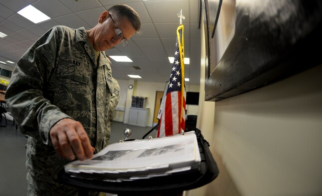 U.S. Air Force Lt. Gen. Timothy Ray, Third Air Force and 17th Expeditionary Air Force commander, admires a “Square D” Heritage display Sept. 9, 2015, on RAF Mildenhall, England. After reviewing the display Ray and U.S. Air Force Chief Master Sgt. Kaleth Wright, Third Air Force and 17th Expeditionary Air Force command chief, were asked to sign the heritage book to log the history of distinguished visitors that viewed the display. (U.S. Air Force photo by Staff Sgt. Micaiah Anthony/Released)