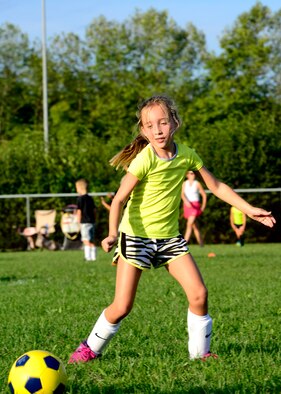 Olivia Donner passes a soccer ball during practice, Sept. 8, 2015, at Aviano Air Base, Italy. The Aviano Youth Program hosts soccer practice for different age groups twice a week. The soccer season, which ends Oct. 31, is the largest AYP program with more than 300 participants. (U.S. Air Force photo by Senior Airman Areca T. Bell/Released)