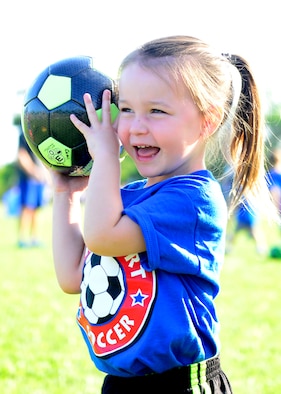 Ava Metivier throws a soccer ball during “Smart Start” Sept. 8, 2015 at Aviano Air Base, Italy. The Aviano Youth Program hosts two separate Smart Start sessions per week, which allows parents and children to get familiarized with soccer. Additionally, AYP offers children an opportunity to gain skills at an early age in sports such as basketball, baseball and flag football. (U.S. Air Force photo by Senior Airman Areca T. Bell/Released)