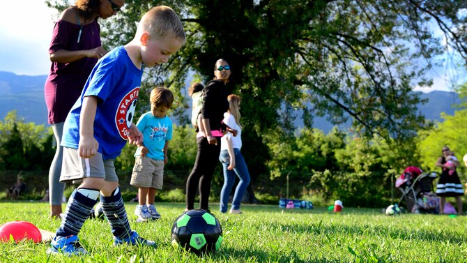 Benjamin Hauser practices passing a soccer ball during “Smart Start,” Sept. 8, 2015, at Aviano Air Base, Italy. Smart Start is a parent-interactive, soccer familiarization program for three to four year old children. The Aviano Youth Program offers the opportunity to gain skills at an early age in sports such as basketball, baseball and flag football. (U.S. Air Force photo by Senior Airman Areca T. Bell/Released)