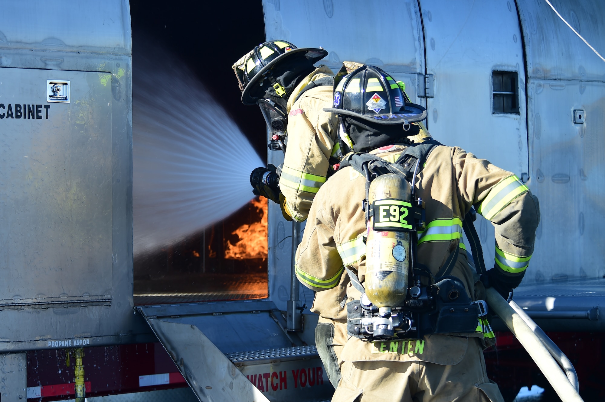 Fire fighters from the Bennett Fire Department extinguish a simulated plane fire Sept. 10, 2015, at Front Range Airport, Colo. A joint operation was conducted by Buckley Air Force Base personnel and surrounding community emergency responders during an annual major accident response exercise. (U.S. Air Force photo by Airman 1st Class Luke W. Nowakowski/Released) 