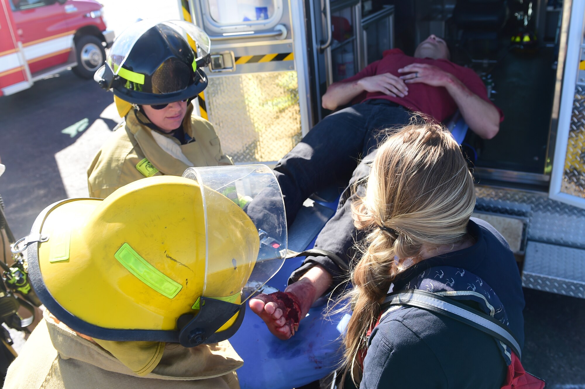 Bennett Fire Department first responders load a simulated casualty into the back of an ambulance Sept. 10, 2015, at Front Range Airport, Colo. A joint operation was conducted by Buckley Air Force Base personnel and surrounding community emergency responders during an annual major accident response exercise. (U.S. Air Force photo by Airman 1st Class Luke W. Nowakowski/Released) 