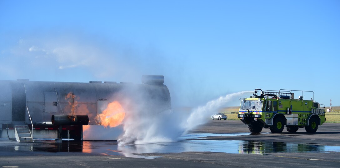 A fire truck from the Front Range Airport dowses a simulated airplane fire Sept. 10, 2015, at Front Range Airport, Colo. A joint operation was conducted by Buckley Air Force Base and surrounding community emergency responders during an annual major accident response exercise. (U.S. Air Force photo by Airman 1st Class Luke W. Nowakowski/Released) 
