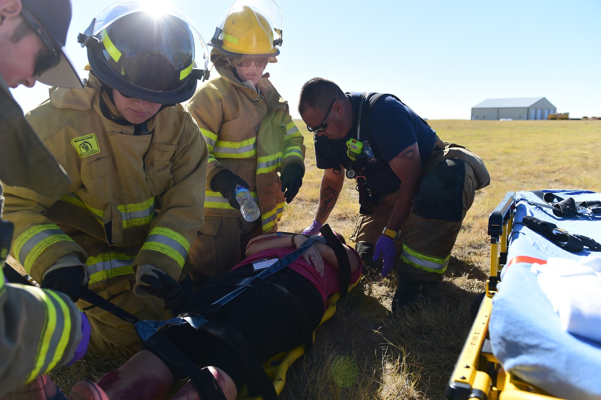 Bennett Fire Department first responders help secure a simulated casualty Sept. 10, 2015, at Front Range Airport, Colo. A joint operation was conducted by Buckley Air Force Base and surrounding community emergency responders during an annual major accident response exercise. (U.S. Air Force photo by Airman 1st Class Luke W. Nowakowski/Released) 