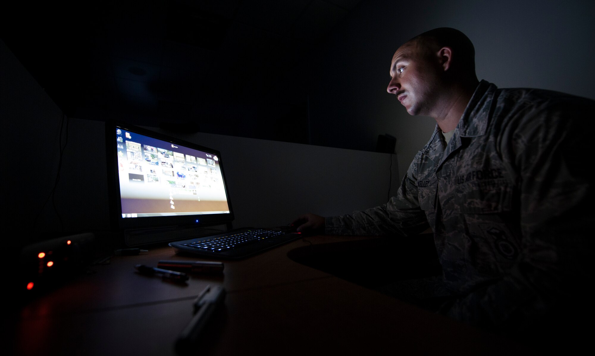 Staff Sgt. Gerald Kelley, 11th Security Forces Squadron training instructor, manipulates exercises during a training session at the 11 SFS training building on Joint Base Andrews, Md., Sept. 3, 2015. The Milo system allows instructors to choose from multiple scenario actions.  (U.S. Air Force photo by Airman 1st Class Philip Bryant/Released)