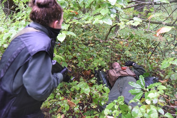 U.S. Air Force Capt. James Broncheau, 13th Fighter Squadron chief of plans and mobility, is interrogated by a simulated enemy combatant during a combat survival training exercise at Draughon Range, Japan, Sept. 9, 2015. When pilots egress into enemy territory, their goal is to successfully survive, evade, resist and escape back to safety. During CSTs, role-players will aggressively hunt downed pilots and re-enact capturing them. (U.S. Air Force photo by Senior Airman Patrick S. Ciccarone/Released) 