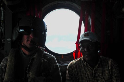 TRUJILLO, Honduras – U.S. Army Staff Sgt. Japheth Shaver, 1-228th Aviation Battalion flight engineer, sits beside a man from Gracias a Dios during a flight to Trujillo, Honduras, Aug. 27, 2015. Joint Task Force-Bravo partnered with the Honduran Government to transport 25 patients and their escorts for eye care as part of Continuing Promise 2015, a U.S. Southern Command-sponsored exercise that builds partnership with nations throughout Central and South America and the Caribbean. (U.S. Air Force photo by Capt. Christopher Love)