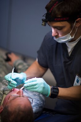 U.S. Air Force Master Sgt. Michael French, from the 158th Communications Flight, receives a dental examination at the Vermont Air National Guard in South Burlington, Vt., June 6. The VTANG has become the first Air Guard base to process both Preventative Health Assessments and Occupational Health Physical Examinations in one large push, improving the medical experience for both sides, and creating a cost-saving and efficient format for other bases to emulate. (U.S. Air National Guard photo by Senior Airman Jon Alderman)