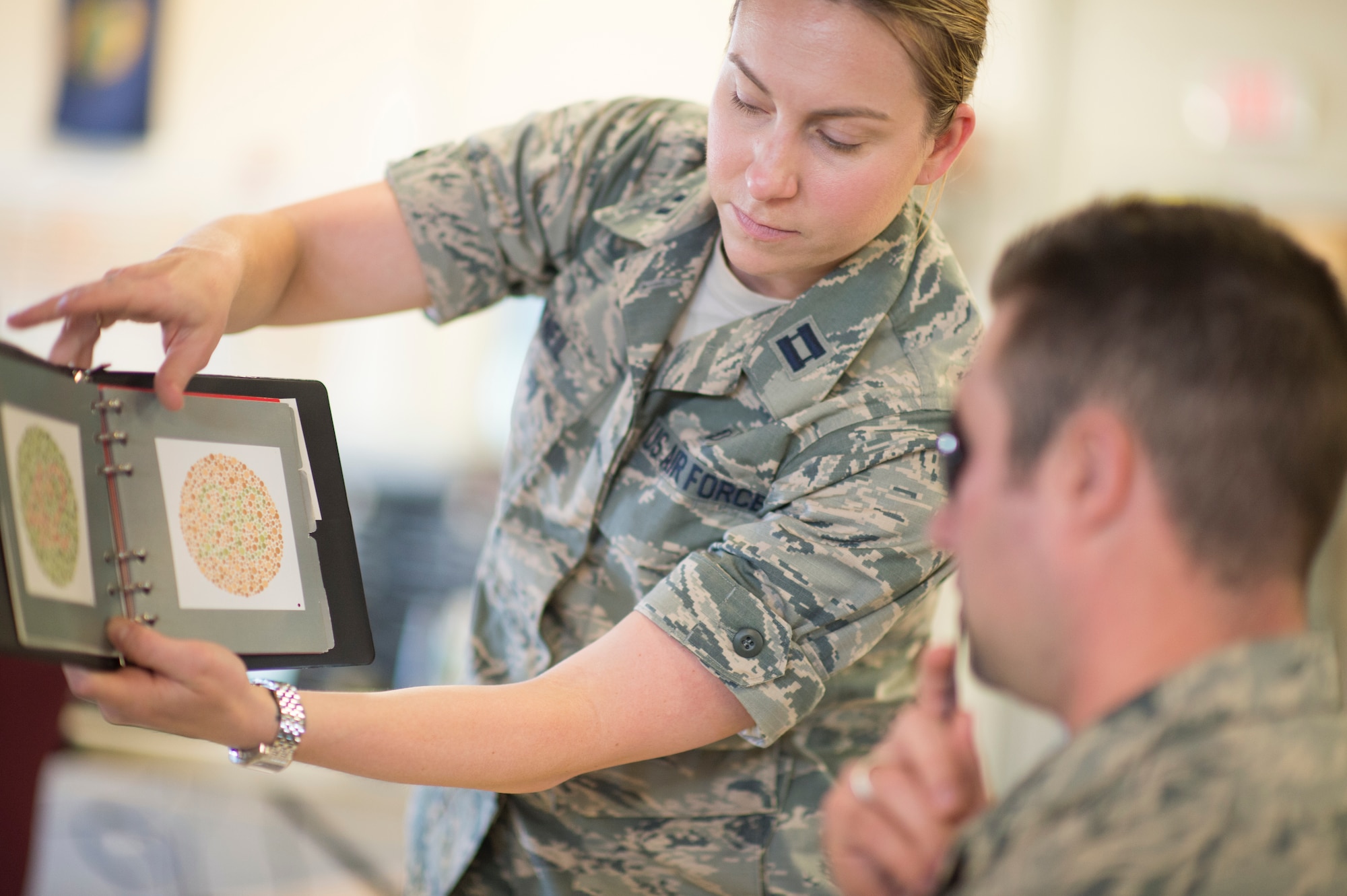 U.S. Air Force Capt. Marcy O'Neil, from the 158th Fighter Wing Medical Squadron, administers a vision exam at the Vermont Air National Guard in South Burlington, Vt., June 6. The 158th Medical Squadron has become the first Air Guard base to process both Preventative Health Assessments and Occupational Health Physical Examinations in one large push, improving the medical experience for both sides, and creating a cost-saving and efficient format for other bases to emulate. (U.S. Air National Guard photo by Senior Airman Jon Alderman)