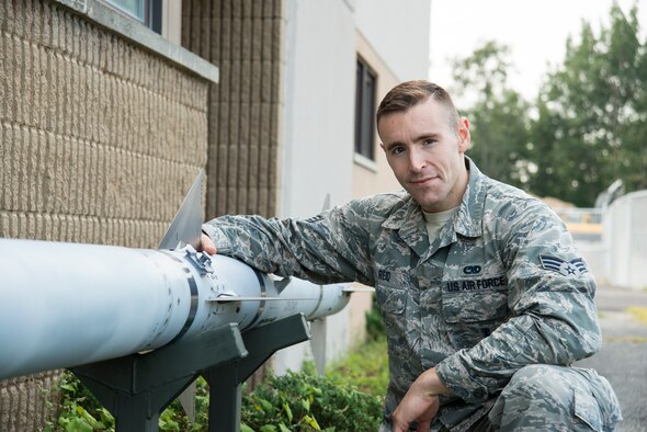 U.S. Air Force Senior Airman Griffin Reid poses beside a static display missile at the Vermont Air National Guard base Sept. 2, 2015. When not on military duty, he helps people who have spent time in jail reintegrate back into the community. (U.S. Air National Guard photo by Airman 1st Class Jeffrey Tatro)