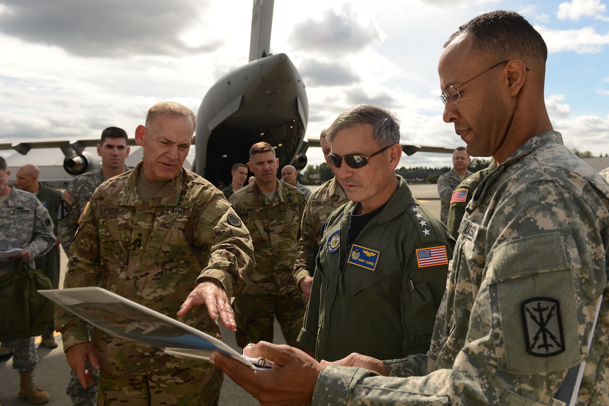 Lt. Gen. Stephen Lanza (left), I Corps commander, briefs Admiral Harry B. Harris Jr., (center), Pacific Command commander, on the High Mobility Artillery Rocket System, Sept. 8, 2015, at Joint Base Lewis-McChord, Wash. The HiMARS is a GPS guided rocket firing system. (U.S. Air Force photo/Staff Sgt. Tim Chacon)