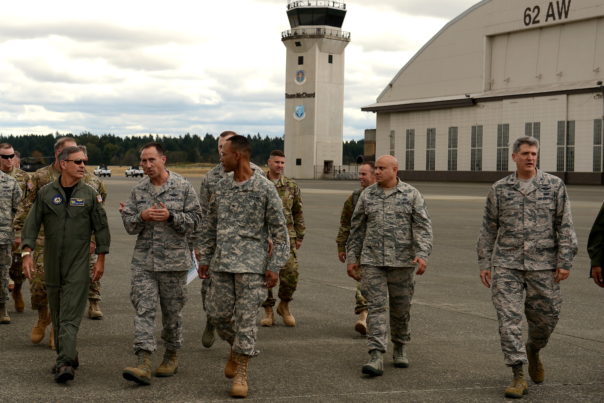 Admiral Harry B. Harris Jr. (far left), Pacific Command commander, receives a brief about the 62nd Airlift Wing from Col. Leonard Kosinski (second from left), 62nd AW commander, Sept. 8, 2015, at Joint Base Lewis-McChord, Wash. Kosinski briefed Admiral Harris about the mission set of the 62nd AW and 446th AW to include: aeromedical evocation, combat air drop, Operation Deep Freeze support and several other special tactics and joint force capabilities. (U.S. Air Force photo/Staff Sgt. Tim Chacon)