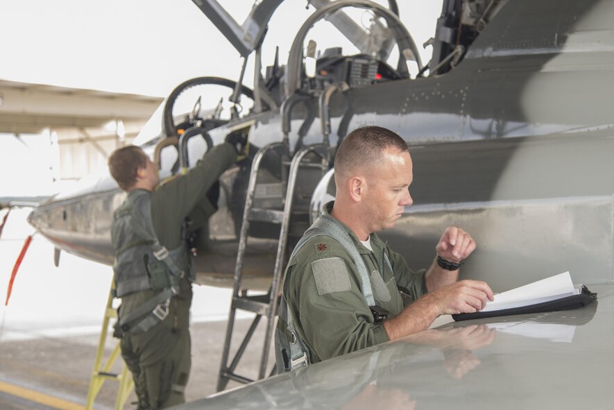Second Lt. Duston Obrien, 435th Fighter Training Squadron upgrade pilot, and Maj. Gavin Peterson, 435th FTS instructor pilot, perform a pre-flight check at Joint Base San Antonio-Randolph, Texas, Sept. 3, 2015. The 435th Fighter Training Squadron conducts Introduction to Fighter Fundamentals student training in nearly 50 T-38C Talon aircraft and trains IFF instructors for Air Education and Training Command at large. The 435th FTS trains approximately 150 students annually from the United States, Iraq, Japan, Poland, Saudi Arabia, and Singapore.