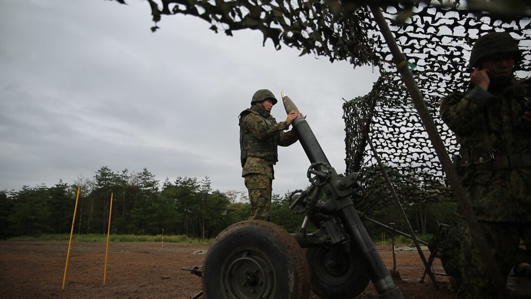 A Japanese Ground Self-Defense Force member prepares to fire a 120mm mortar during Forest Light 16-1 at Camp Imazu, Takashima, Japan, Sept. 6, 2015. The JGSDF and U.S. Marines took turns calling fire missions, prepping the mortar for fire, and firing the mortar. Forest Light is a semi-annual, bilateral exercise consisting of a command post exercise and multiple field training events conducted by elements of III Marine Expeditionary Force and the JGSDF. The JGSDF member is from 50th Infantry Regiment, 14th Brigade.