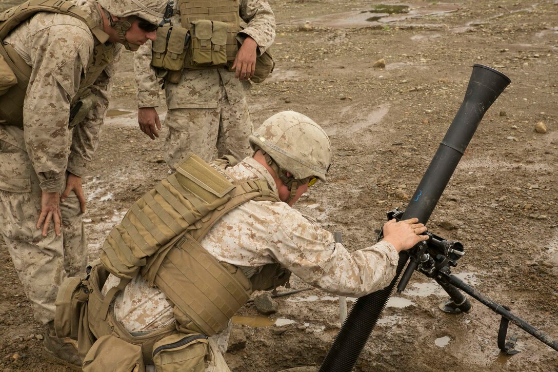 Cpl. Taylor McCullough, bottom, sets up the 81mm mortar during Forest Light 16-1 at Camp Imazu, Takashima, Japan, Sept. 6, 2015. The Japanese Ground Self-Defense Force and U.S. Marines took turns calling fire missions, prepping the mortar for fire, and firing the mortar. Forest Light is a semi-annual, bilateral exercise consisting of a command post exercise and multiple field training events conducted by elements of III Marine Expeditionary Force and the JGSDF. McCullough is a mortarman with 1st Battalion, 2nd Marine Regiment currently assigned to 4th Marine Regiment, 3rd Marine Division, III MEF.