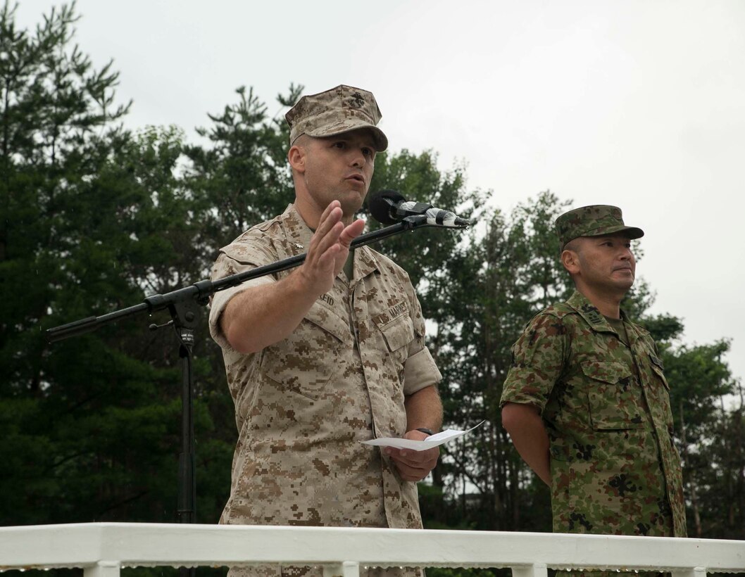 Lt. Col. Eric Reid, left, speaks to the Japanese Ground Self Defense Force and U.S. Marines during the opening ceremony of Forest Light 16-1 at Camp Imazu, Takashima, Japan, Sept. 6, 2015. Forest Light will take place Sept. 7-18 with approximately 240 Marines working next to 350 JGSDF members. The exercise will consist of combined mortar live fire, establishing forward arming and refueling points training, combined helicopter borne skills and combined-arms training. The JGSDF members are from 50th Infantry Regiment, 14th Brigade. The Marines are with 1st Battalion, 2nd Marine Regiment currently assigned to 4th Marine Regiment, 3rd Marine Division, III Marine Expeditionary Force.