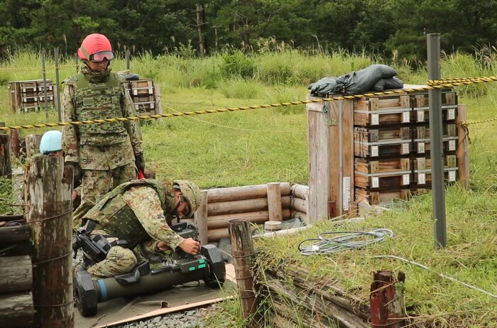 Sgt. Sugimoto Yoshitaka, front, preps the Type 01 LMAT Anti-Tank Missile System while Sgt. 1st Class Haya Yoshihiro watches to ensure proper preparation of the missile during Forest Light 16-1 at Camp Imazu, Takashima, Japan, Sept. 7, 2015. The Japanese Ground Self-Defense Force and U.S. Marines shared knowledge about different anti-tank missile systems. After giving specifications of their respective weapon systems, the two forces used practice rounds to demonstrate how well the weapon systems work. Forest Light will take place Sept. 7-18 with approximately 240 Marines working next to 350 JGSDF members. The exercise will consist of mortar live fire, establishing forward arming and refueling points training, helicopter borne skills and combined arms procedures. Yoshitaka is an anti-tank missile man with 50th Infantry Regiment, 14th Brigade. Yoshihiro is an anti-tank missile man with 50th Infantry Regiment, 14th Brigade.