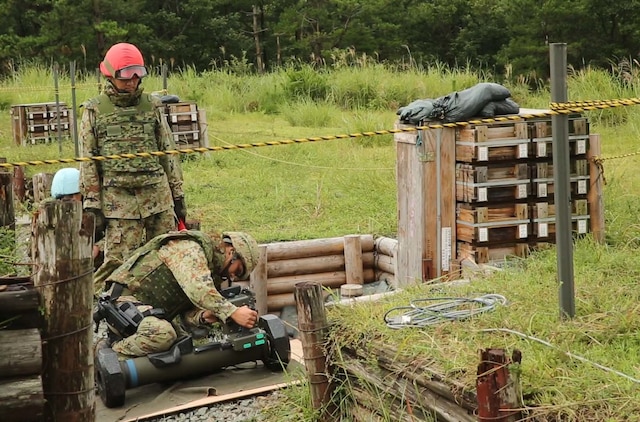 Sgt. Sugimoto Yoshitaka, front, preps the Type 01 LMAT Anti-Tank Missile System while Sgt. 1st Class Haya Yoshihiro watches to ensure proper preparation of the missile during Forest Light 16-1 at Camp Imazu, Takashima, Japan, Sept. 7, 2015. The Japanese Ground Self-Defense Force and U.S. Marines shared knowledge about different anti-tank missile systems. After giving specifications of their respective weapon systems, the two forces used practice rounds to demonstrate how well the weapon systems work. Forest Light will take place Sept. 7-18 with approximately 240 Marines working next to 350 JGSDF members. The exercise will consist of mortar live fire, establishing forward arming and refueling points training, helicopter borne skills and combined arms procedures. Yoshitaka is an anti-tank missile man with 50th Infantry Regiment, 14th Brigade. Yoshihiro is an anti-tank missile man with 50th Infantry Regiment, 14th Brigade.