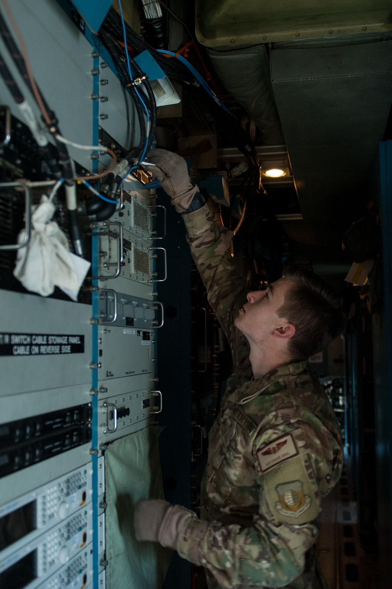 U.S. Air Force Airman 1st Class Chase Krol, 41st Expeditionary Electronic Combat Squadron airborne maintenance technician, completes a post-flight inspection on an EC-130H Compass Call aircraft at Bagram Airfield, Afghanistan, Sept. 6, 2015. The Compass Call is an airborne tactical weapon system using a heavily modified version of the C-130 Hercules airframe. (U.S. Air Force photo by Tech. Sgt. Joseph Swafford/Released)