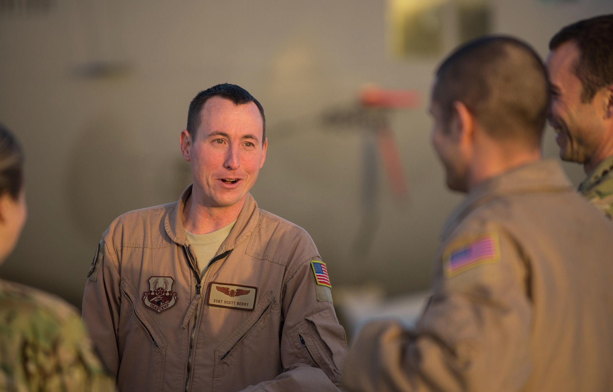 U.S. Air Force Staff Sgt. Scott Berry, 41st Expeditionary Electronic Combat Squadron mission crew supervisor, talks with teammates during an EC-130H Compass Call aircraft final mission meeting on the flight line at Bagram Airfield, Afghanistan, Sept. 6, 2015. The Compass Call is an airborne tactical weapon system using a heavily modified version of the C-130 Hercules airframe. (U.S. Air Force photo by Tech. Sgt. Joseph Swafford/Released)