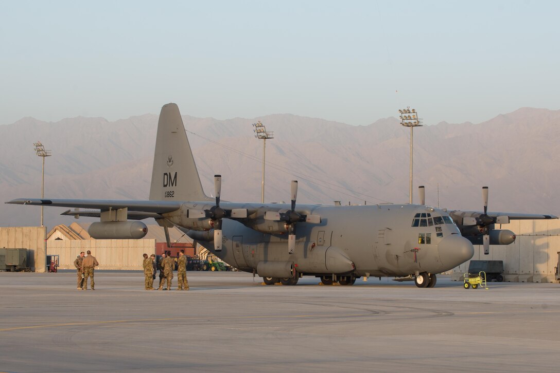 U.S. Airmen assigned to the 41st Expeditionary Electronic Combat Squadron talk during an EC-130H Compass Call aircraft final mission meeting on the flight line at Bagram Airfield, Afghanistan, Sept. 6, 2015.  The Compass Call is an airborne tactical weapon system using a heavily modified version of the C-130 Hercules airframe. (U.S. Air Force photo by Tech. Sgt. Joseph Swafford/Released)