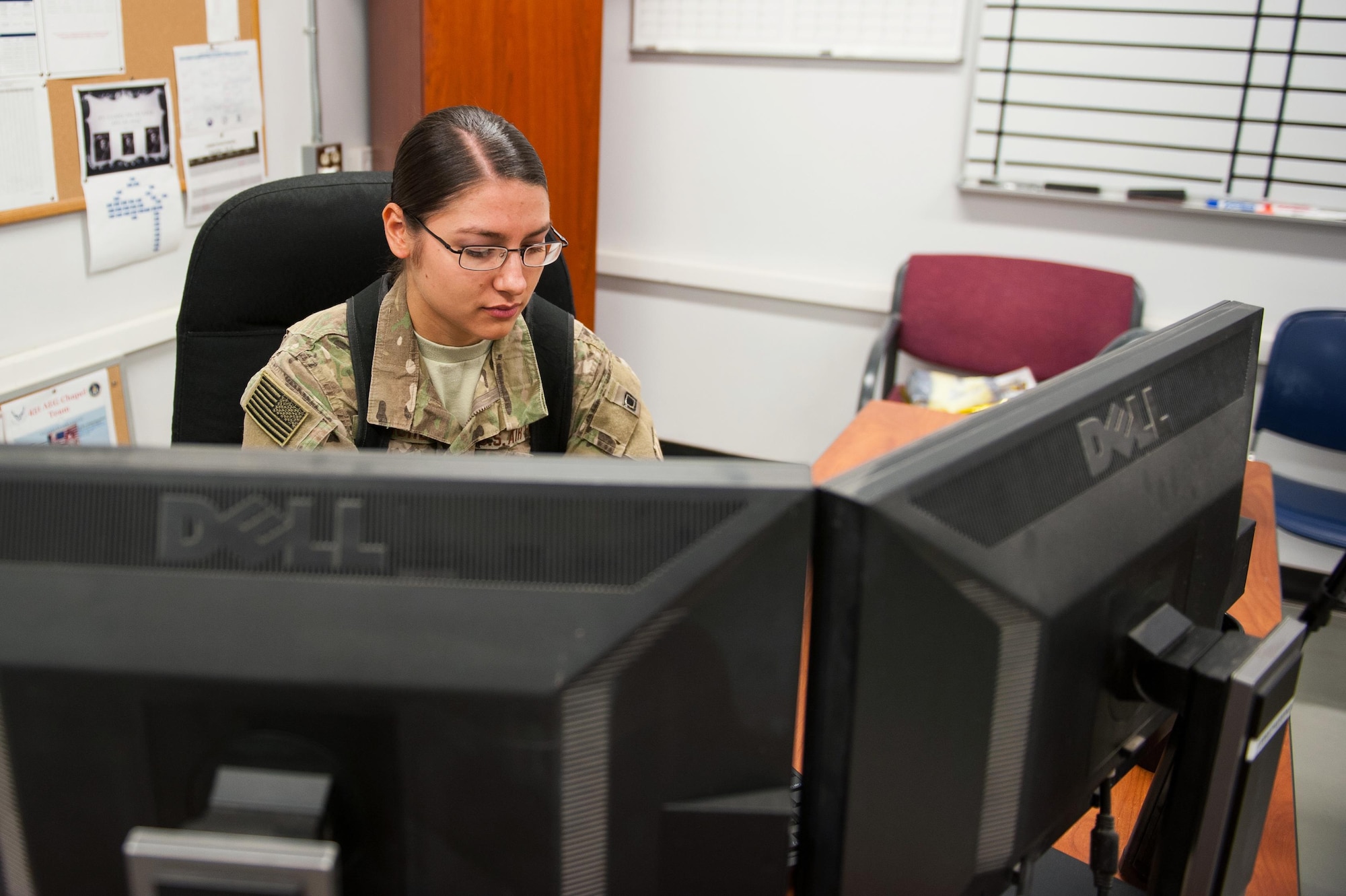 U.S. Air Force Senior Airman Jamie, 62nd Expeditionary Reconnaissance Squadron intel analyst, goes over intel reports at Kandahar Airfield, Aug. 14, 2015. Jamie receives intel products and goes through them to provide tactical briefs to the aircrew. (U.S. Air Force photo by Tech. Sgt. Joseph Swafford/Released)