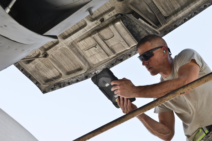 Staff Sgt. Eugene Wilson, 379th Expeditionary Aircraft Maintenance Squadron, 746th Expeditionary Aircraft Maintenance Unit, reads through his technical orders to ensure he followed proper instruction for maintenance on a C-130 Hercules engine September 9, 2015 at Al Udeid Air Base, Qatar. The 746th AMU airmen are responsible for ensuring aircraft are maintained to exact standards to support Operation Inherent Resolve. Wilson is deployed out of 911th Airlift Wing, Pittsburgh International Airport Air Reserve Station, Coraopolis, Pa. (U.S. Air Force photo/Staff Sgt. Alexandre Montes)  