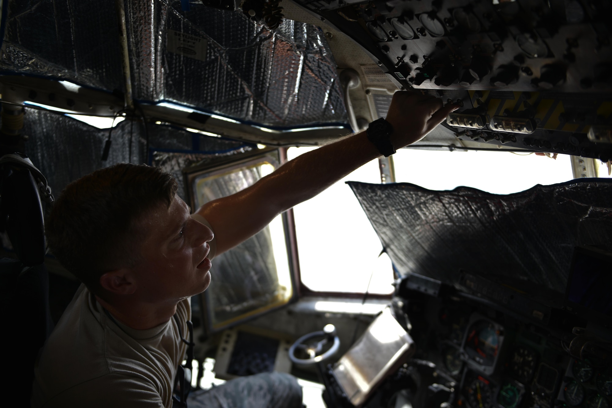 Senior Airman Ryan Patrick, 379th Expeditionary Aircraft Maintenance Squadron, 746th Expeditionary Aircraft Maintenance Unit, tests the lamination of each gauge inside the cockpit of a C-130 Hercules during a routine maintenance inspection September 9, 2015 at Al Udeid Air Base, Qatar. The 746th AMU airmen are responsible for ensuring aircraft are maintained to exact standards to support Operation Inherent Resolve. Patrick is a deployed member of the 911th Airlift Wing, Pittsburgh International Airport Air Reserve Station, Pa. (U.S. Air Force photo/Staff Sgt. Alexandre Montes)  