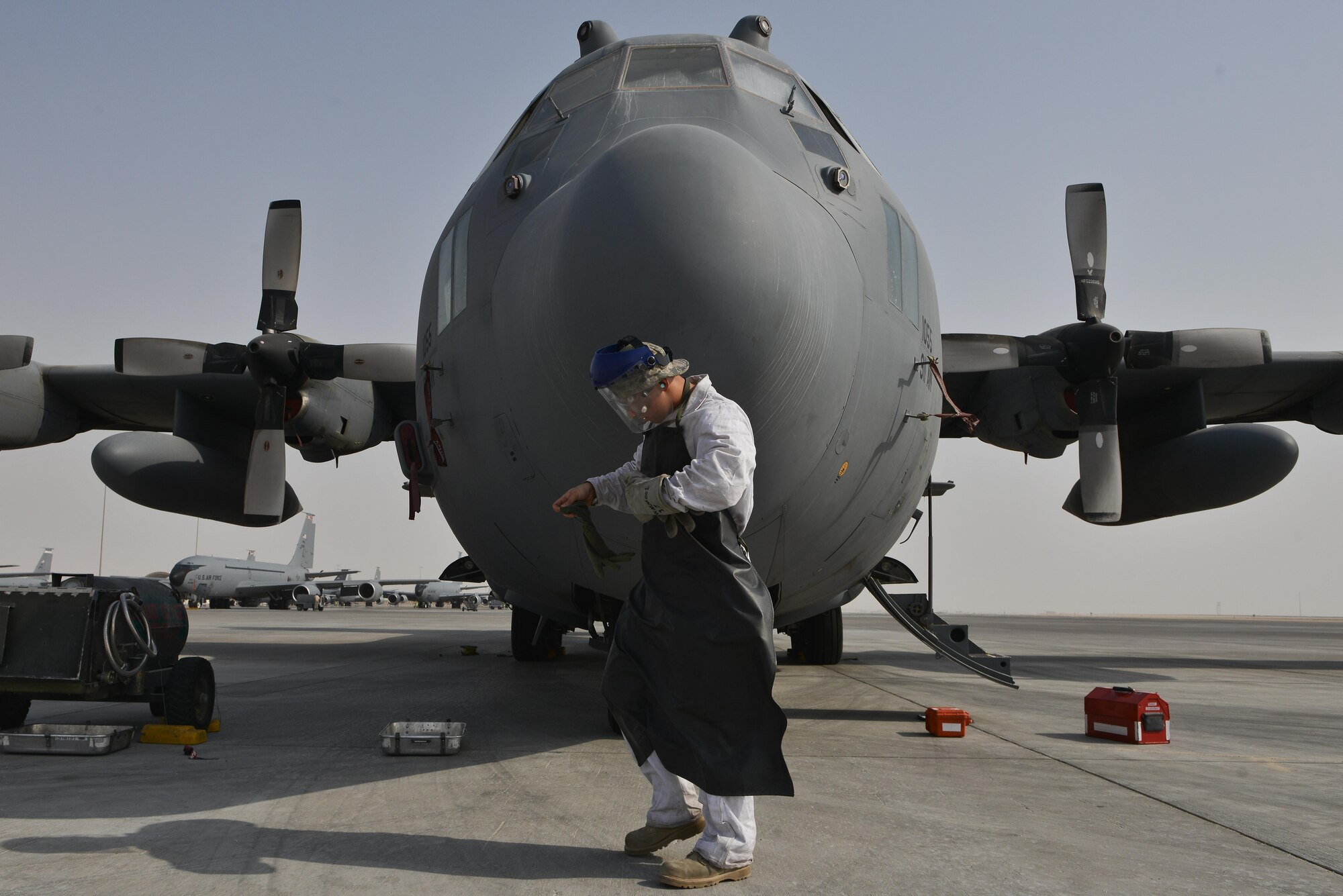 Senior Airman Matthew Krzywiecki, 379th Expeditionary Aircraft Maintenance Squadron, 746th Expeditionary Aircraft Maintenance Unit, puts on his personal protective equipment prior to working with liquid oxygen September 9, 2015 at Al Udeid Air Base, Qatar. The 746th AMU cryogenics airmen work with liquid nitrogen and liquid oxygen that is recharged into aircraft, providing aircrews with pure oxygen at altitude during missions in support of Operation Inherent Resolve. Krzywiecki is a deployed member from the 911th Airlift Wing, Pittsburgh International Airport Air Reserve Station, Pa. U.S. Air Force photo/Staff Sgt. Alexandre Montes)  