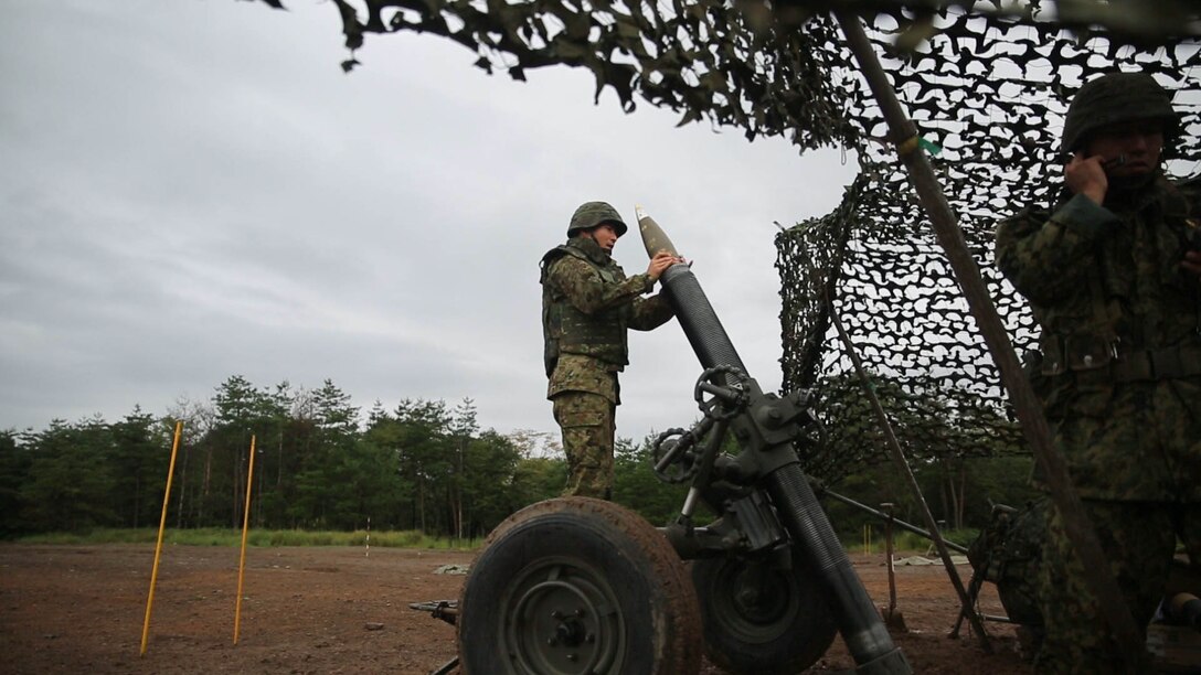 A Japan Ground Self-Defense Force member prepares to fire a 120mm mortar during Forest Light 16-1 at Camp Imazu, Takashima, Japan, Sept. 6, 2015. The JGSDF and U.S. Marines took turns calling fire missions, prepping the mortar for fire, and firing the mortar. Forest Light is a semi-annual, bilateral exercise consisting of a command post exercise and multiple field training events conducted by elements of III Marine Expeditionary Force and the JGSDF. The JGSDF member is from 50th Infantry Regiment, 14th Brigade. 