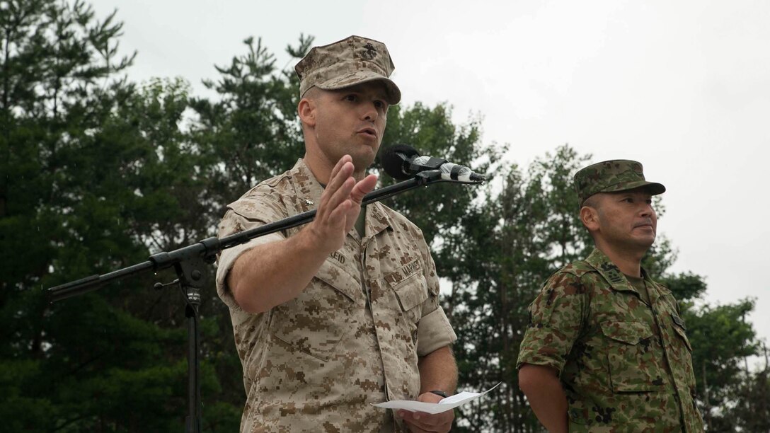 Lt. Col. Eric Reid, left, speaks to the Japan Ground Self Defense Force and U.S. Marines during the opening ceremony of Forest Light 16-1 at Camp Imazu, Takashima, Japan, Sept. 6, 2015. Forest Light will take place Sept. 7-18 with approximately 240 Marines working next to 350 JGSDF members. The exercise will consist of combined mortar live fire, establishing forward arming and refueling points training, combined helicopter borne skills and combined-arms training. The JGSDF members are from 50th Infantry Regiment, 14th Brigade. The Marines are with 1st Battalion, 2nd Marine Regiment currently assigned to 4th Marine Regiment, 3rd Marine Division, III Marine Expeditionary Force. 