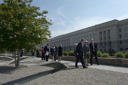 James J. Townsend Jr., right, the deputy assistant secretary of defense for European and NATO policy, and Jim Laychak, third from right, the president of the Pentagon Memorial Fund, escort Queen Silvia of Sweden on a tour of the Pentagon Memorial in Arlington, Virginia, May 10, 2013. The queen laid flowers at the memorial bench for Dana Falkenberg, the youngest person killed in the Sept. 11 attack on the Pentagon. Observances will occur today as the terror attacks are remembered.
