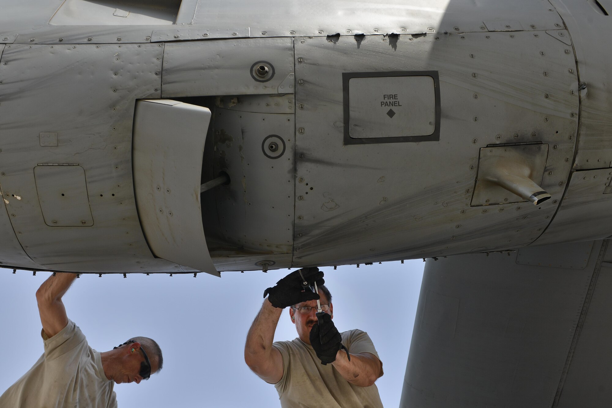 Staff Sgt. Eugene Wilson and Master Sgt. Daniel Gothe, 379th Expeditionary Aircraft Maintenance Squadron, 746th Expeditionary Aircraft Maintenance Unit, remove the bolts of a C-130 Hercules engine panel to make internal inspections September 9, 2015 at Al Udeid Air Base, Qatar. The 746th AMU airmen are responsible for ensuring aircraft are maintained to exact standards to support Operation Inherent Resolve. Wilson and Gothe are deployed members of the 911th Airlift Wing, Pittsburgh International Airport Air Reserve Station, Pa. (U.S. Air Force photo/Staff Sgt. Alexandre Montes)  