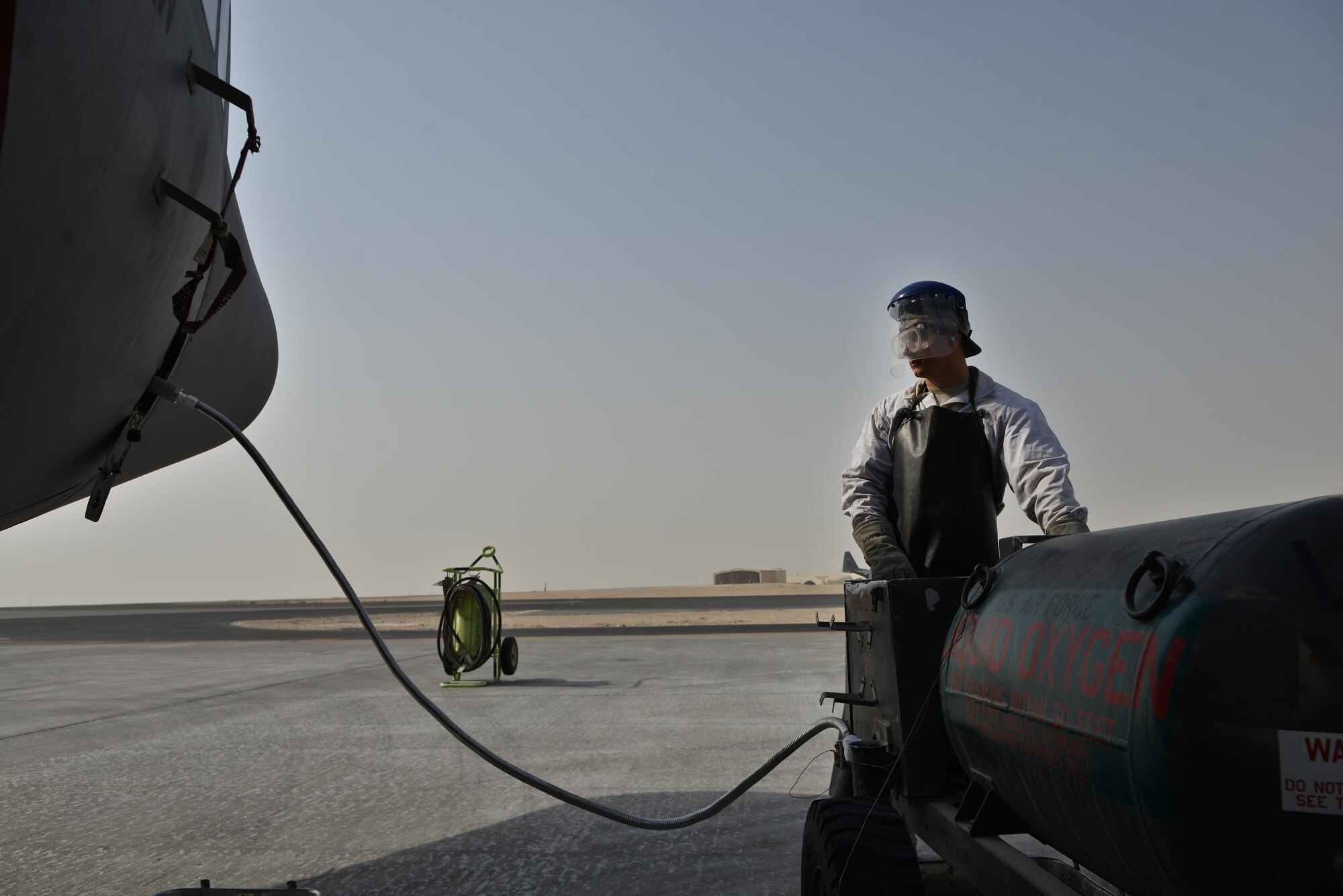 Senior Airman Matthew Krzywiecki, 379th Expeditionary Aircraft Maintenance Squadron, 746th Expeditionary Aircraft Maintenance Unit, recharges a C-130 Hercules with liquid oxygen September 9, 2015 at Al Udeid Air Base, Qatar. The 746th AMU cryogenics airmen work with liquid nitrogen and liquid oxygen that is recharged into aircraft providing aircrews with pure oxygen at altitude during missions in support of Operation Inherent Resolve. Krzywiecki is a deployed member from the 911th Airlift Wing, Pittsburgh International Airport Air Reserve Station, Pa. (U.S. Air Force photo/Staff Sgt. Alexandre Montes)  