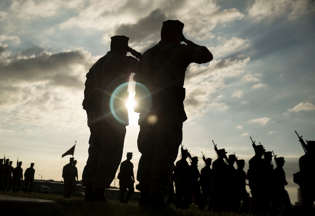 Lt. Gens. John Wissler and Larry Nicholson salute Marines during the pass and review portion of the III Marine Expeditionary Force change of command ceremony at Camp Foster, Okinawa, Japan, Sept. 11, 2015. Wissler, who has been the III MEF commanding general for the past two years, relinquished his command to Nicholson. Wissler is a native of Camp Pendleton, Calif.; Nicholson is a native of Toronto.