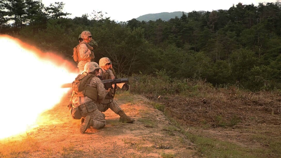 Cpl. Brandon Crain yells fire to Lance Cpl. Clayton Baker while demonstrating the capabilities of the shoulder-launched multipurpose assault weapon to the Japan Ground Self-Defense Force during Forest Light 16-1 at Camp Imazu, Takashima, Japan, Sept. 7, 2015. The JGSDF and U.S. Marines took turns sharing knowledge about different anti-tank missile systems. After giving specifications of their respective weapon systems, the two forces used practice rounds to demonstrate how well the weapon systems work. Forest Light will take place Sept. 7-18 with approximately 240 Marines working next to 350 JGSDF members. The exercise will consist of mortar live fire, establishing forward arming and refueling points training, helicopter borne skills and combined arms procedures. Crain is from Leander, Texas and Baker is from Huntington, Indiana. Both Marines are assaultmen with 1st Battalion, 2nd Marine Regiment currently assigned to 4th Marine Regiment, 3rd Marine Division, III Marine Expeditionary Force. 