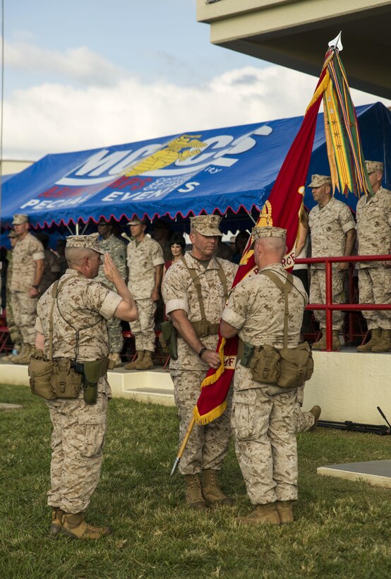 Lt. Gen. John Wissler, middle, passes the III Marine Expeditionary Force colors to Lt. Gen. Larry Nicholson, at Camp Foster, Okinawa, Japan, Sept. 11, 2015. At the change of command ceremony, Wissler relinquished command to Nicholson. Wissler is a native of Camp Pendleton, Calif.; Nicholson is a native of Toronto.
